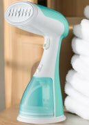 Plancha a vapor eléctrica portátil Tendeli en color verde claro, ideal para mantener la ropa sin arrugas.